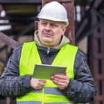 construction worker confused reading ipad