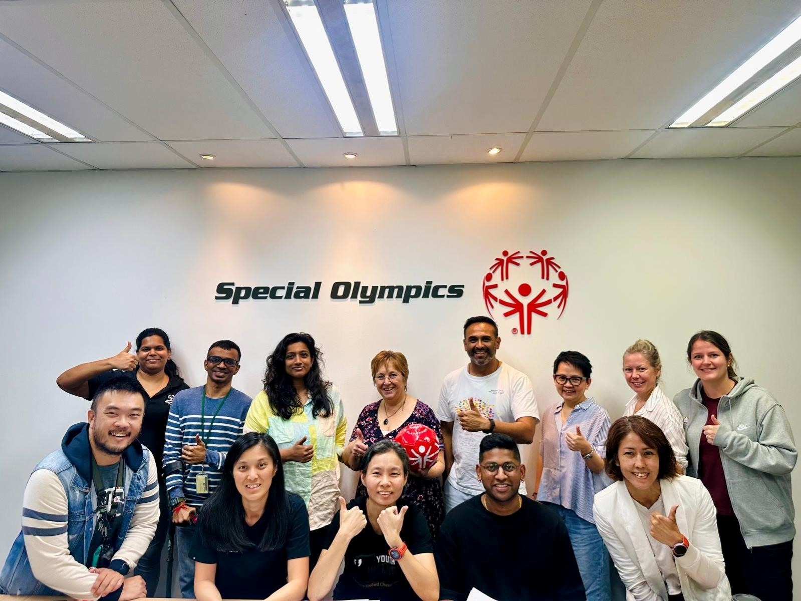 Cathy and the crew from Special Olympics Asia Pacific smiling with thumbs up at the end of 3 day training.